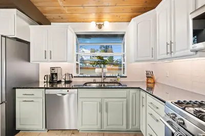 a white kitchen with a sink and a window at Luxury Hilltop Stay Pool, Firepit and Views in La Mesa