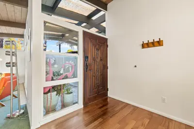 a hallway with a door and a room with a table at Luxury Hilltop Stay Pool, Firepit and Views in La Mesa