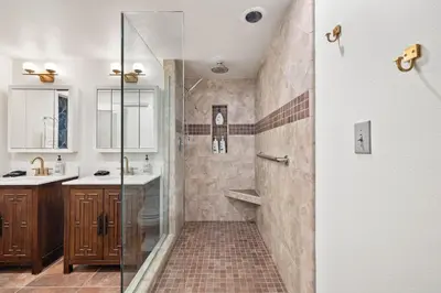a bathroom with a shower with a glass door at Luxury Hilltop Stay Pool, Firepit and Views in La Mesa