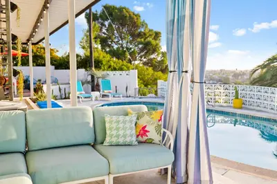 a couch on a patio next to a swimming pool at Luxury Hilltop Stay Pool, Firepit and Views in La Mesa