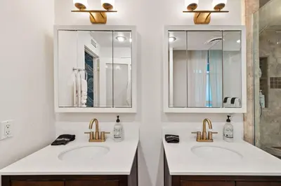 a bathroom with two sinks and two mirrors at Luxury Hilltop Stay Pool, Firepit and Views in La Mesa