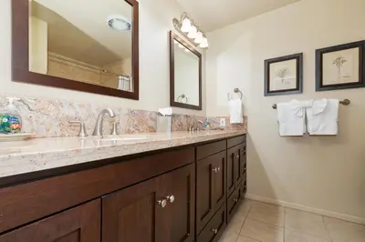 a bathroom with two sinks and a large mirror at Crown Point 3BR Bay and Beach View Parking W D in San Diego
