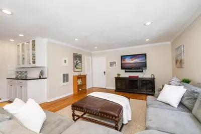 a living room with a couch and a flat screen tv at Crown Point 3BR Bay and Beach View Parking W D in San Diego