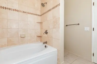 a bathroom with a white tub and a shower at Crown Point 3BR Bay and Beach View Parking W D in San Diego