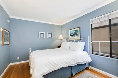 a blue bedroom with a bed and a window at Crown Point 3BR Bay and Beach View Parking W D in San Diego