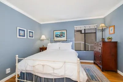 a bedroom with a white bed and blue walls at Crown Point 3BR Bay and Beach View Parking W D in San Diego