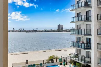 a view of the beach from the balcony of a building at Crown Point 3BR Bay and Beach View Parking W D in San Diego