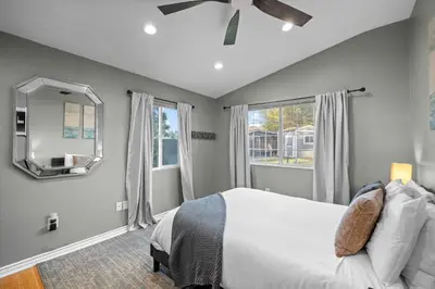 a bedroom with a bed and a ceiling fan at Modern Oceanside Stay with Yard & Laidback Vibes in Oceanside