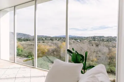 a room with a large window with mountains in the background at Glass Home with Views, Hot Tub, FREE EV Charging! in Bonita