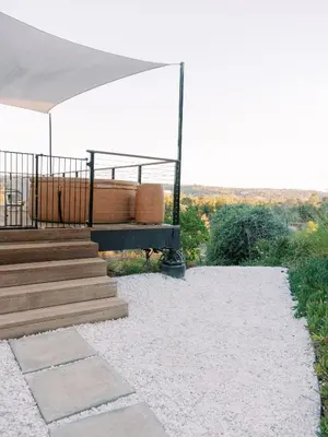 a patio with a white tent and stairs with a view at Glass Home with Views, Hot Tub, FREE EV Charging! in Bonita