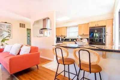 a kitchen and living room with a red couch at Walk to Beach • La Jolla Home + Free Parking in San Diego