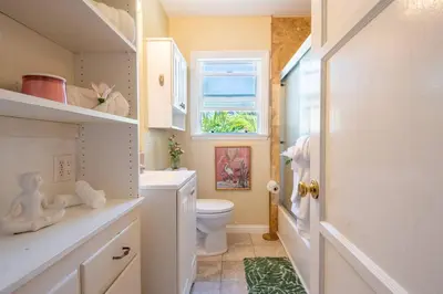 a bathroom with a toilet and a window at Walk to Beach • La Jolla Home + Free Parking in San Diego