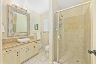 a bathroom with a toilet and a sink and a shower at Costa del Sol in Newport Beach