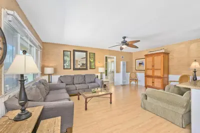 a living room with couches and a ceiling fan at Costa del Sol in Newport Beach