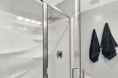 a shower with a glass door and two towels at Solana Beach Escape, Beach Access, AC, Pools, Spa, Tennis Courts & Clubhouse Views in Solana Beach
