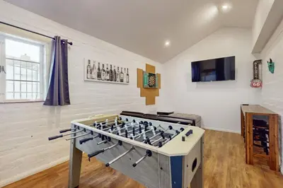 a living room with a large chess set in the center at La Jolla Historic Gem, Hot Tub, Game Room, Garden Oasis with Firepit & Courtyard Dining in San Diego