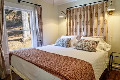 a bedroom with a large bed with a window at 320 Acres Farmhouse in East County San Diego