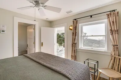 a bedroom with a bed and a window and a chair at 320 Acres Farmhouse in East County San Diego