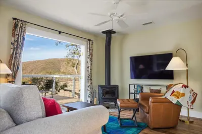a living room with a couch and a fireplace at 320 Acres Farmhouse in East County San Diego
