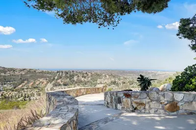 a stone wall with a view of a city at Casa Grotto in San Marcos