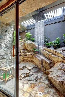 a stone wall with a water fountain in a room at Casa Grotto in San Marcos