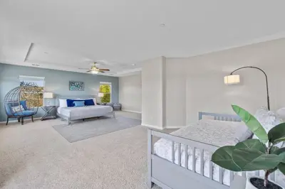 a bedroom with a bed and a living room at Sunset Crest - Home with stunning views, Pool, BBQ in Fallbrook