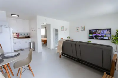 a living room with a bed and a kitchen at King Suite - 2min Walk to Beach Close to Downtown! in Oceanside