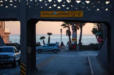 a car parked in a parking lot next to the ocean at King Suite - 2min Walk to Beach Close to Downtown! in Oceanside