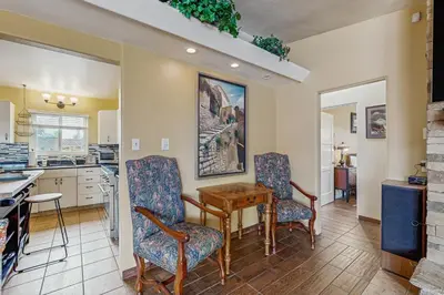 a kitchen with two chairs and a table in a room at Seabreeze Bungalow in Oceanside