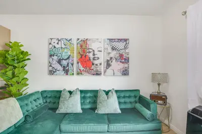 a living room with a green couch with pillows at Golden Hill Gem 2 Mi to Gaslamp Quarter - Dogs OK! in San Diego