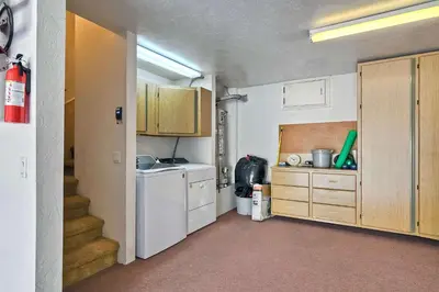 a kitchen with a washer and dryer and a staircase at Beachfront Sunset in Encinitas