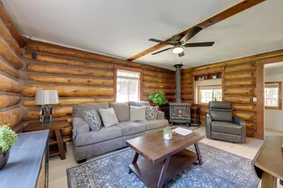 a living room with a couch and a wood wall at Hike, Bike and Explore Woodsy Retreat in Mt Laguna! in Mount Laguna