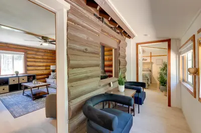 a living room with wooden walls and blue chairs at Hike, Bike and Explore Woodsy Retreat in Mt Laguna! in Mount Laguna