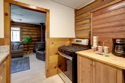 a kitchen with wooden walls and a stove top oven at Hike, Bike and Explore Woodsy Retreat in Mt Laguna! in Mount Laguna
