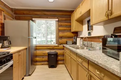 a kitchen with wooden cabinets and a refrigerator at Hike, Bike and Explore Woodsy Retreat in Mt Laguna! in Mount Laguna