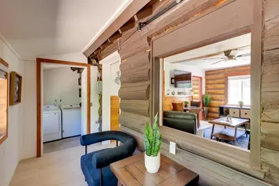 a living room with a wooden wall and a mirror at Hike, Bike and Explore Woodsy Retreat in Mt Laguna! in Mount Laguna