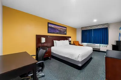 a hotel room with a bed and a desk at Quality Inn San Diego South - Chula Vista in Chula Vista