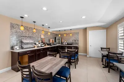 a restaurant with tables and chairs and a kitchen at Quality Inn San Diego South - Chula Vista in Chula Vista