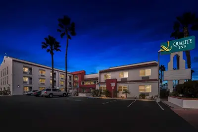 a hotel parking lot with a sign for a quality inn at Quality Inn San Diego South - Chula Vista in Chula Vista