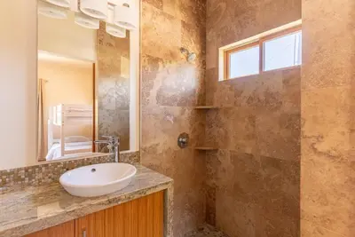 a bathroom with a sink and a mirror at Luxury Mountain Estate Sleeps 11 in Valley Center