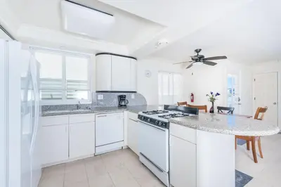 a kitchen with white cabinets and a counter top at Pet-Friendly 4Br Oceanview Getaway Steps From 35Th St Beach By Beachview Rentals in Newport Beach