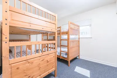 a bedroom with two bunk beds and a staircase at Pet-Friendly 4Br Oceanview Getaway Steps From 35Th St Beach By Beachview Rentals in Newport Beach