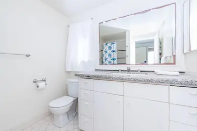 a white bathroom with a toilet and a mirror at Pet-Friendly 4Br Oceanview Getaway Steps From 35Th St Beach By Beachview Rentals in Newport Beach