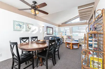 a dining room and living room with a table and chairs at Retro 3Br With Oceanview Patio In A Very Walkable Location By Beachview Rentals in Newport Beach