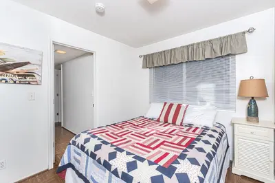 a bedroom with a bed and a window at Retro 3Br With Oceanview Patio In A Very Walkable Location By Beachview Rentals in Newport Beach