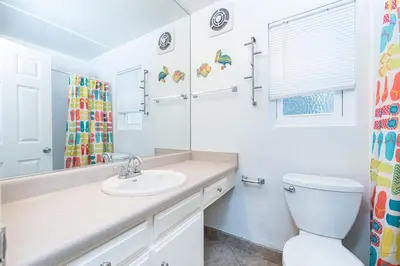 a bathroom with a sink and a toilet at Retro 3Br Split-Level W Oceanview Patio Steps To Sand By Beachview Rentals in Newport Beach