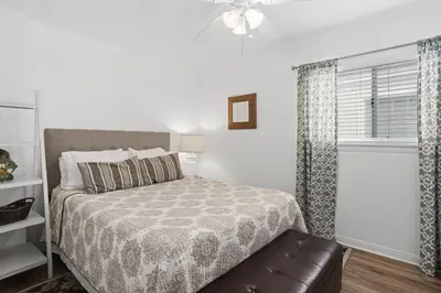 a bedroom with a bed and a window at Oceanview Corner Home W Rooftop Deck, One House From Beach By Beachview Rentals in Newport Beach