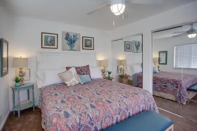 a bedroom with a bed and a mirror at 4Br Coastal Retreat Seconds From Popular 40Th Street Beach By Beachview Rentals in Newport Beach