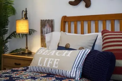 a bedroom with a bed with a pillow on it at 6Br Duplex W Oceanview Patios, Steps To 40Th Street Beach By Beachview Rentals in Newport Beach
