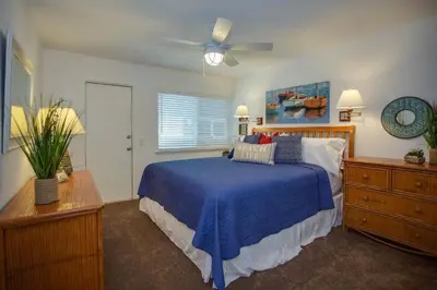 a bedroom with a bed and a ceiling fan at 6Br Duplex W Oceanview Patios, Steps To 40Th Street Beach By Beachview Rentals in Newport Beach